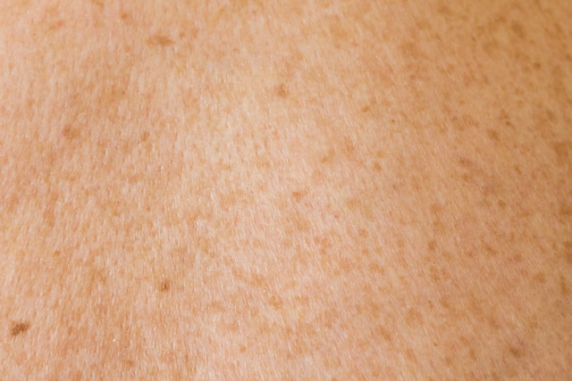 鏡の前で肌の状態を確認する女性の顔のアップ
