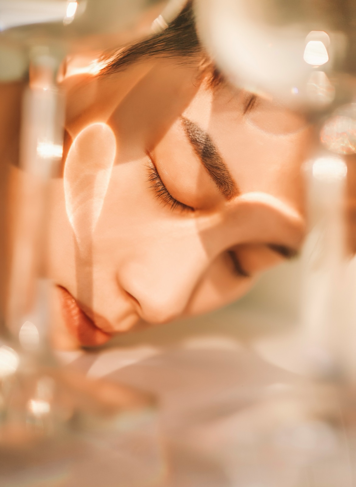 暖かい光の中で目を閉じている女性の肌